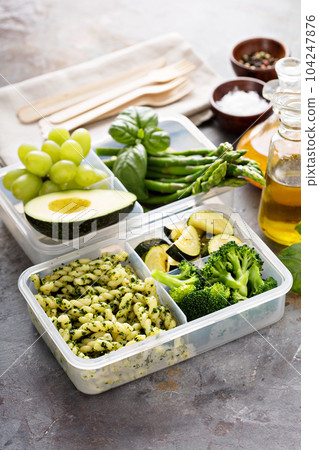 Vegan meal prep containers with pasta and vegetables 104247876