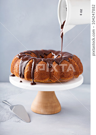 Vanilla bundt cake with chocolate glaze Vanilla bundt cake with chocolate glaze 104247882