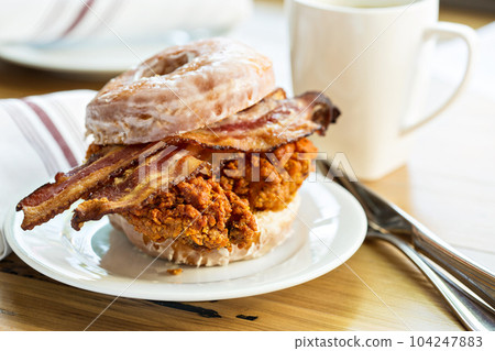 Hot spicy fried chicken and bacon sandwich in a donut Hot spicy fried chicken and bacon sandwich in a donut 104247883