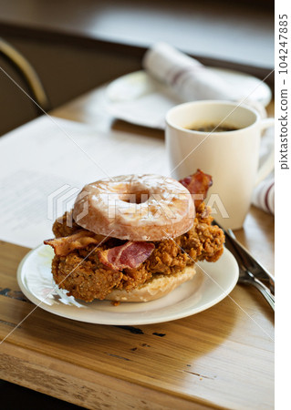 Fried chicken and bacon sandwich in a donut Fried chicken and bacon sandwich in a donut 104247885