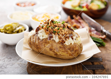 Baked potato with pulled pork Baked potato with pulled pork 104247891