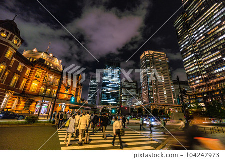 Tokyo cityscape in Japan Summer solstice: At the Marunouchi North Exit of Tokyo Station, people rush to go home ... = June 21, after 20:00 Tokyo cityscape in Japan Summer solstice: At the Marunouchi North Exit of Tokyo Station, people rush to go home ... = June 21, after 20:00 104247973