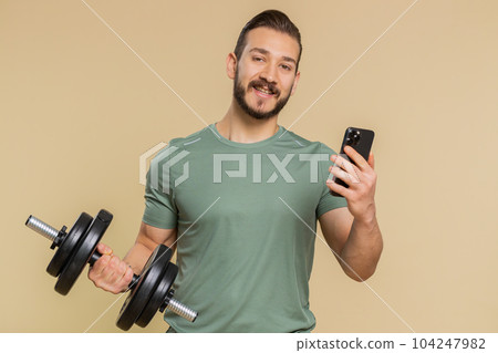 Athlete man use smartphone typing new post on web sms message browsing addiction of social networks 104247982