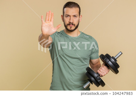Athlete sportive man say no hold hand palm in stop gesture, warning of finish do not be afraid 104247983