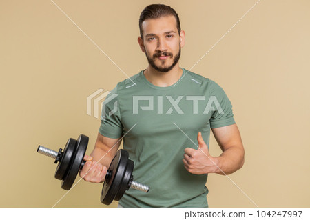 Athlete man looking approvingly at camera showing thumbs up, like sign positive something good Athlete man looking approvingly at camera showing thumbs up, like sign positive something good 104247997