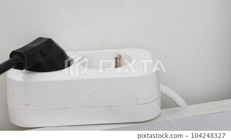 Plugging a socket plug into a double extension cord Plugging a socket plug into a double extension cord 104248327