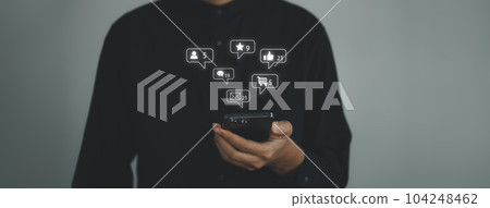 Business man touch the screen on smart phone with emotion icons. social network and social media marketing concept. Business man touch the screen on smart phone with emotion icons. social network and social media marketing concept. 104248462