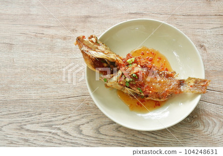 batter fried red grouper fish dressing sweet and spicy chili sauce on plate batter fried red grouper fish dressing sweet and spicy chili sauce on plate 104248631