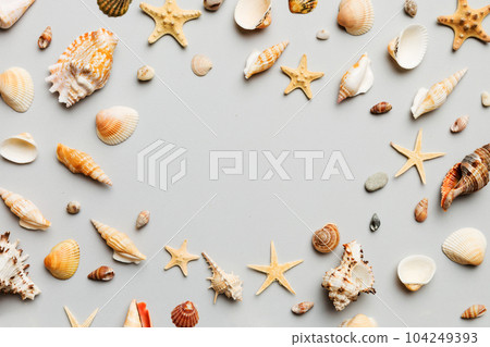 Summer time concept Flat lay composition with beautiful starfish and sea shells on colored table, top view with copy space for text Summer time concept Flat lay composition with beautiful starfish and sea shells on colored table, top view with copy space for text 104249393
