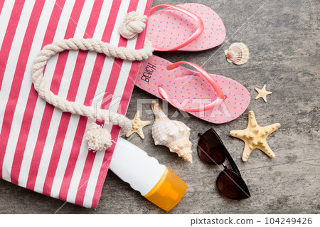beach accessories flat lay top view on colored background Summer travel concept. Bag with starfish and sea shell. Top view beach accessories flat lay top view on colored background Summer travel concept. Bag with starfish and sea shell. Top view 104249426