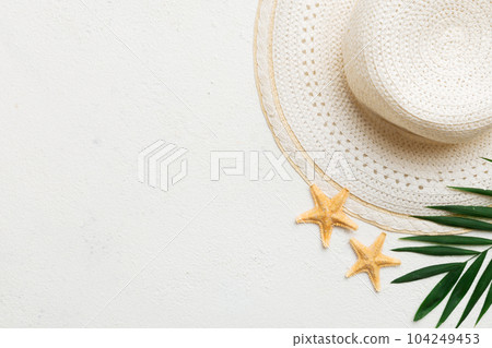 Summer holidays. Summer concept with straw hat and tropical leaf. Flat lay, top view, copy space Summer holidays. Summer concept with straw hat and tropical leaf. Flat lay, top view, copy space 104249453