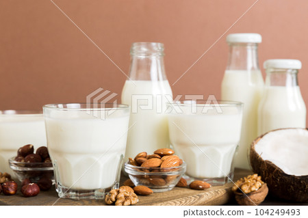 Set or collection of various vegan milk almond, coconut, cashew, on table background. Vegan plant based milk and ingredients, top view Set or collection of various vegan milk almond, coconut, cashew, on table background. Vegan plant based milk and ingredients, top view 104249493