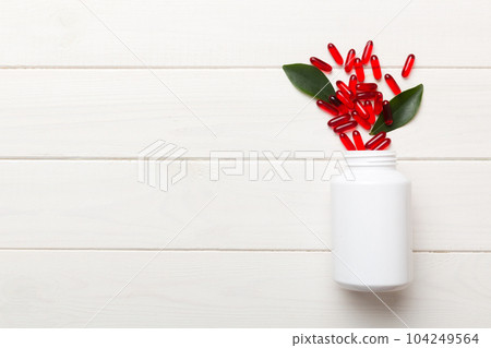 different drugs and health supplement pills poured from a medicine bottle health care and medical top view on colored background different drugs and health supplement pills poured from a medicine bottle health care and medical top view on colored background 104249564