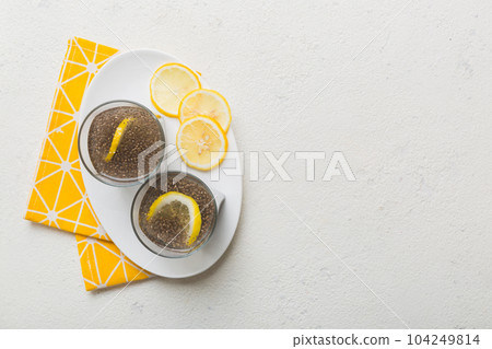 Healthy breakfast or morning with chia seeds and lemon on table background, vegetarian food, diet and health concept. Chia pudding with lemon Healthy breakfast or morning with chia seeds and lemon on table background, vegetarian food, diet and health concept. Chia pudding with lemon 104249814