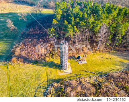 Wooden lookout tower in Hermanice on sunny spring day, Czech Republic. Aerial view from drone. 104250262