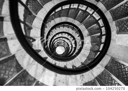 Old vintage spiral staircase. Black and white photography. 104250278
