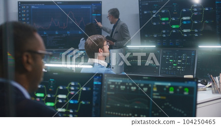 Technical support specialists sit at computers 104250465