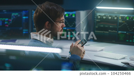 Professional IT technical specialist chats using phone Professional IT technical specialist chats using phone 104250466