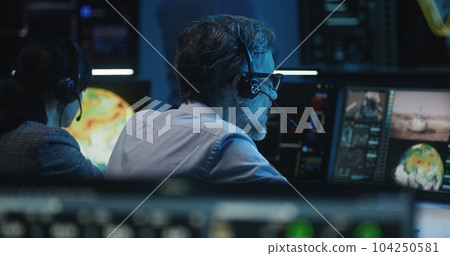 Flight control workers monitor successful space rocket launch Flight control workers monitor successful space rocket launch 104250581