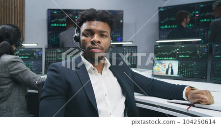 Financial analyst turns and looks at camera Financial analyst turns and looks at camera 104250614