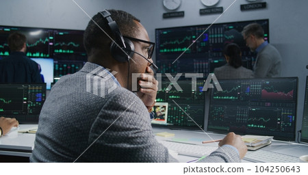 African American investor with pen in hand works African American investor with pen in hand works 104250643