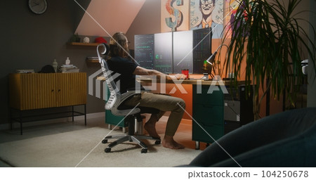 Male trader analyzes exchange market charts, eats delivery food Male trader analyzes exchange market charts, eats delivery food 104250678