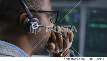 African American financial analyst looks at computer screen 104250911