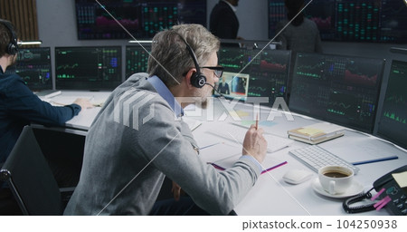Male trader works on computer with real-time stocks Male trader works on computer with real-time stocks 104250938