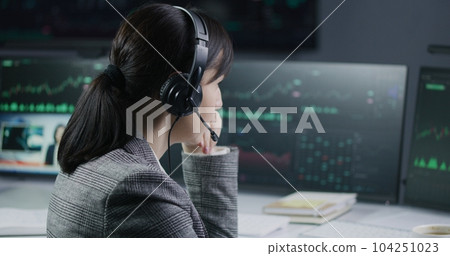 Close up shot of female financial analyst working in bank office 104251023