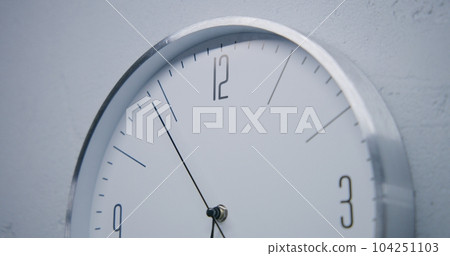 White watch with metal frame hangs and shows time 104251103
