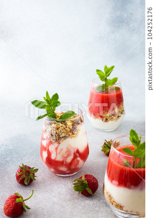 Granola and yogurt and strawberry smoothie 104252176