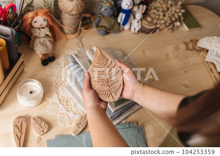Creative Corner. Details on a wooden work table, scissors, thread, fabrics. . High quality photo 104253359