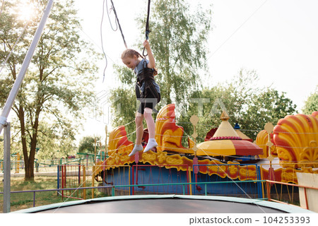 Happy schoolgirl having fun at an adventure park on a summer day. High quality photo Happy schoolgirl having fun at an adventure park on a summer day. High quality photo 104253393