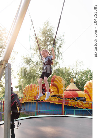 Happy schoolgirl having fun at an adventure park on a summer day. High quality photo Happy schoolgirl having fun at an adventure park on a summer day. High quality photo 104253395