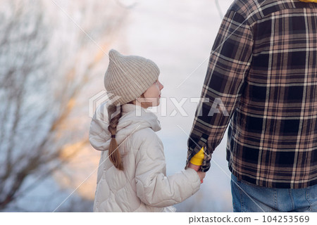 Happy Father's Day concept: Father and daughter standing on a meadow spring background near the river . High quality photo 104253569