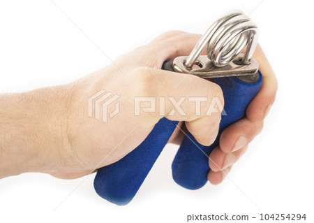 Blue rubber expander for sports, on a white background and in a male hand. A hand squeezes an expander. Forearm and grip Blue rubber expander for sports, on a white background and in a male hand. A hand squeezes an expander. Forearm and grip 104254294