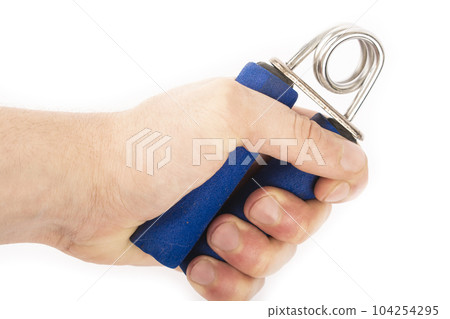 Blue rubber expander for sports, on a white background and in a male hand. A hand squeezes an expander. Forearm and grip Blue rubber expander for sports, on a white background and in a male hand. A hand squeezes an expander. Forearm and grip 104254295
