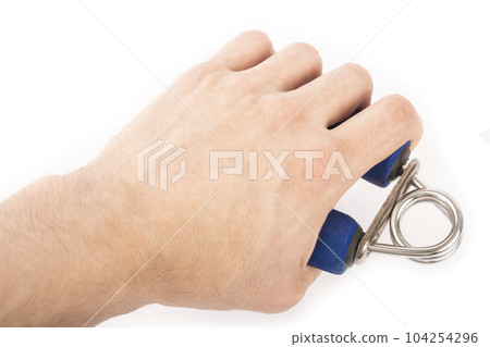Blue rubber expander for sports, on a white background and in a male hand. A hand squeezes an expander. Forearm and grip Blue rubber expander for sports, on a white background and in a male hand. A hand squeezes an expander. Forearm and grip 104254296