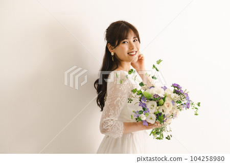 A woman in a wedding dress, a bride with a bouquet A woman in a wedding dress, a bride with a bouquet 104258980