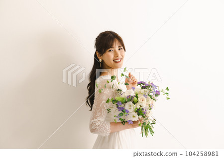 A woman in a wedding dress, a bride with a bouquet A woman in a wedding dress, a bride with a bouquet 104258981