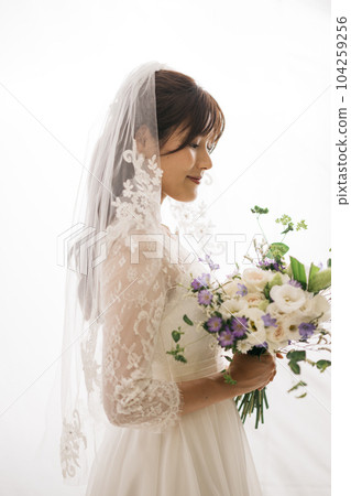 A woman in a wedding dress, a bride with a bouquet A woman in a wedding dress, a bride with a bouquet 104259256