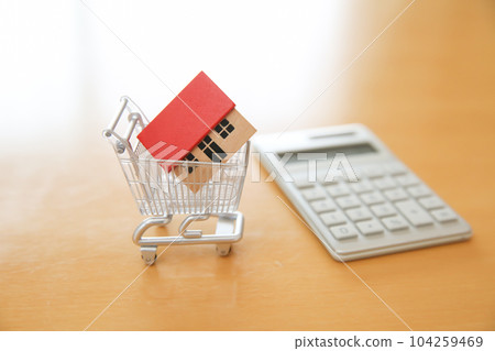 Housing Real estate purchase Money image House model and calculator in shopping cart 104259469