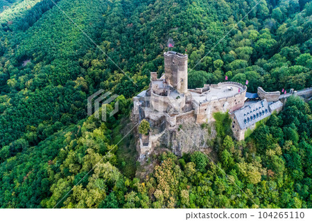 aerial view rock with medieval castle Ehrenburg on it near moselle river in Brodenbach with forest hills 104265110