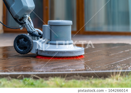 manual cleaning of concrete and stone terraces of the house with a professional scrubber 104266014