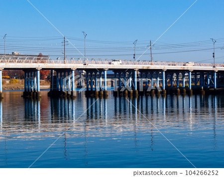 Kyobashi, with its continuous piers reflected on the river surface of Asahikawa Kyobashi, with its continuous piers reflected on the river surface of Asahikawa 104266252