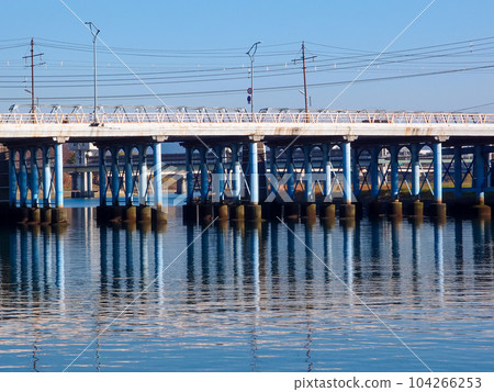 Kyobashi, with its continuous piers reflected on the river surface of Asahikawa Kyobashi, with its continuous piers reflected on the river surface of Asahikawa 104266253