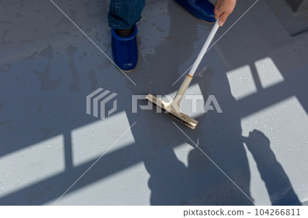 A man cleaning the balcony Balcony A man cleaning the balcony Balcony 104266811
