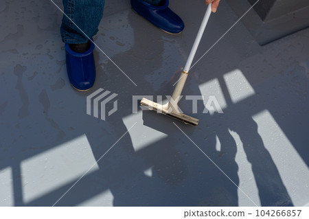 A man cleaning the balcony Balcony A man cleaning the balcony Balcony 104266857