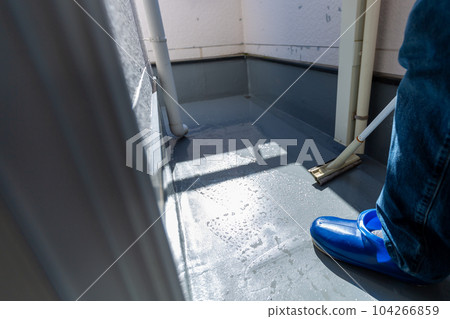 A man cleaning the balcony Balcony A man cleaning the balcony Balcony 104266859