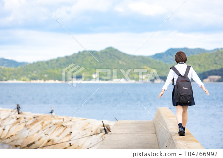 High school girl walking on embankment 104266992